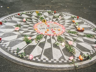 Commemorative mosaic "Imagine" at Strawberry Fields, adorned with flowers and candles to honor John Lennon.