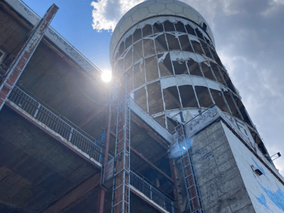 Diving view of the listening station at Teufelsberg, with graffiti and sunlight filtering through the clouds.