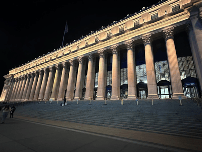 Majestic facade of the General Post Office illuminated at night, showcasing its imposing columns and classical architecture.