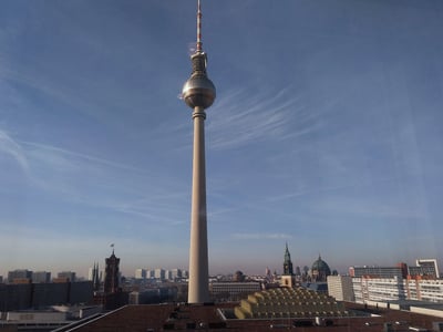TV Tower in Berlin, view of the city with a blue sky and historical buildings in the background.