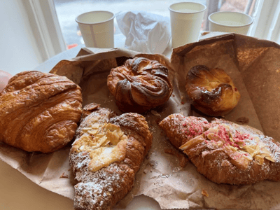 Varied croissants and pastries on a table at L'Appartement 4F, offering a delightful sweet selection.