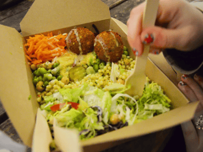 Colorful salad with falafels at the Upmarket Brick Lane Food Hall, showcasing fresh and tasty ingredients.