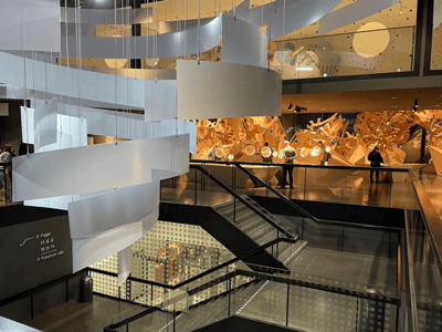 Interior of the Futurium in Berlin, featuring modern architecture with futuristic artworks in the background.