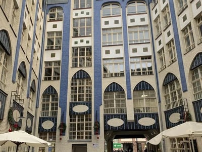 Inner courtyard of the Hackesche Höfe with historic buildings and visitors enjoying the unique architecture.
