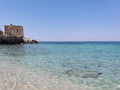 Peaceful beach in Melendugno with turquoise and clear water, ideal for swimming and water activities.