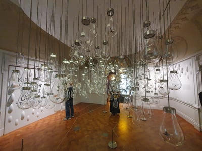 Art installation with glass hangings at the Cooper Hewitt Museum, adding a modern touch to the space.