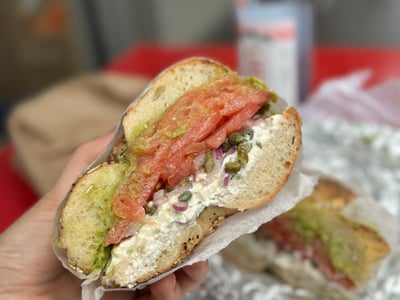 Bagel topped with smoked salmon, avocado, and cream cheese, enjoyed at Pick a Bagel in New York. Authentic and fresh flavors.