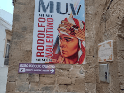 Colorful artistic poster at the Rodolfo Valentino Museum, highlighting the actor's cinematic legacy.