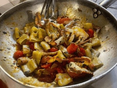 Delicious seafood pasta, prepared with fresh tomatoes, served at Trattoria Piaceri e Tradizione.