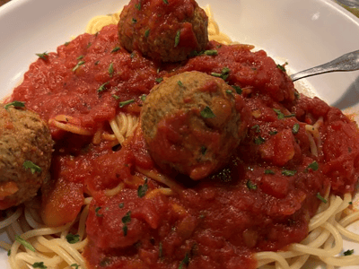 Spaghetti with meatballs, topped with delicious tomato sauce, served at Olive Garden.