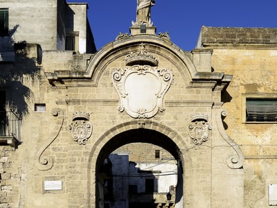 The Gate of the Jews, a historic gate adorned with a statue, symbolizes the cultural heritage of the region.