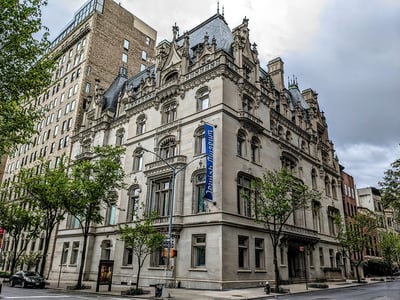 Jewish Museum of New York, historic building with elegant architecture, surrounded by trees and lively urban life.