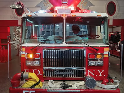 FDNY fire truck in the rescue area, with flashing lights on and equipment ready for intervention.