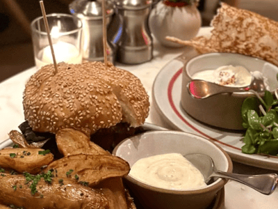 Delicious hamburger with golden fries served at Pier 17, offering a unique seaside dining experience.