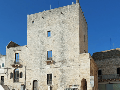 Medieval tower at Torre Grande, featuring stone architecture and a beautiful sunny day.