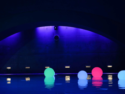 Colorful lights floating on the water at Liquidrom, creating a relaxing and modern atmosphere for visitors.
