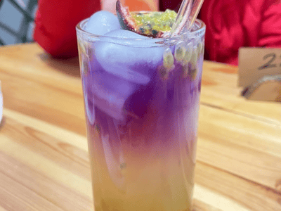 Colorful fruit-based drink at Café de Luna, showcasing vibrant shades of purple and orange.