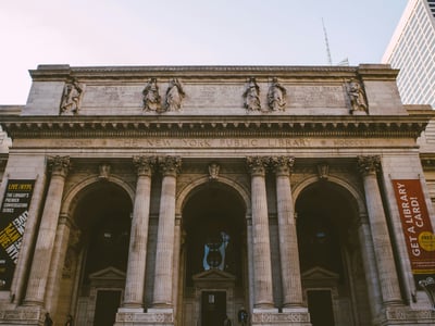 Majestic facade of the New York Public Library, a cultural emblem with imposing columns and sculptures.