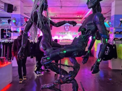 Futuristic sculpture of cyborgs in the Cyberdog store, vibrant neon lighting and distinct cybernetic atmosphere.