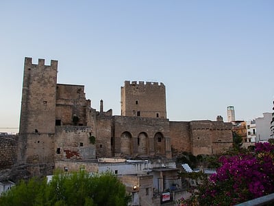 Impressive view of the Castello Episcopio in Pizzoli, a fusion of history and medieval architecture under a serene sky.