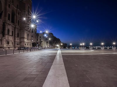 A stroll at sunset along the Lungomare Vittorio Emanuele II, illuminated by streetlamps, offering a peaceful view of the sea.