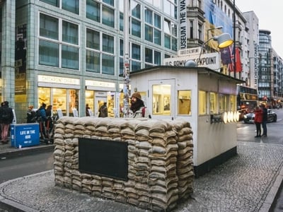 Historical checkpoint at Checkpoint Charlie, with sandbags, a symbol of the Cold War in Berlin.