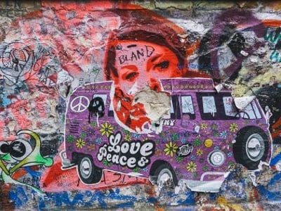 Colored wall at Haus Schwarzenberg, featuring a retro van with elements of peace and love, representing urban culture.