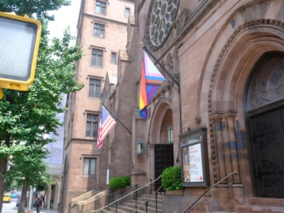Église Saint-Jacques à New York, affichant des drapeaux inclusifs et une architecture impressionnante.