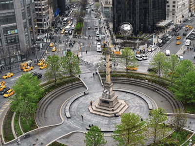 Columbus Circle animated with yellow taxis, lush trees, and a central statue, reflecting New York City's energy.