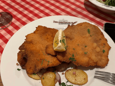 Crispy schnitzel served with potatoes and a slice of lemon at the Berliner Republik.