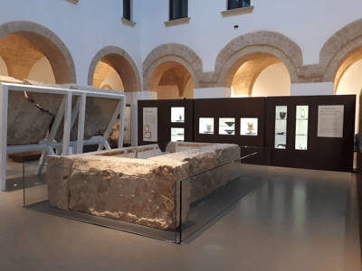 Exhibition of archaeological remains at the New Archaeological Museum, highlighting local history through artifacts.