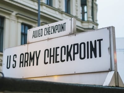 Sign indicating Checkpoint Charlie, an emblematic symbol of the Cold War in Berlin.