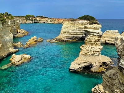 Torre Sant'Andrea beach with its white rock formations and turquoise waters, ideal for swimming and exploration.