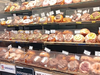 Colorful display of donuts at Camden Lock Market, featuring a variety of enticing and creative toppings.