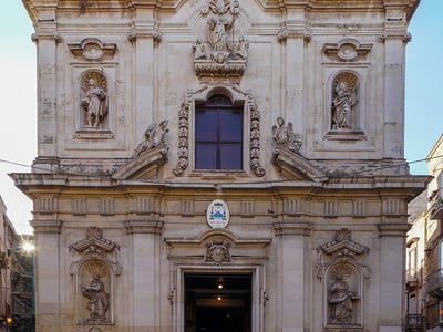 Facade of the Cattedrale Duomo di San Cataldo in Catania, adorned with sculptures and Baroque elements, emblematic of the city.