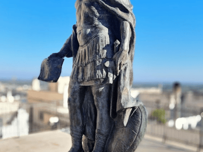 Statue of a Roman warrior overlooking the city from the Cattedrale Santa Maria Assunta à Cielo.