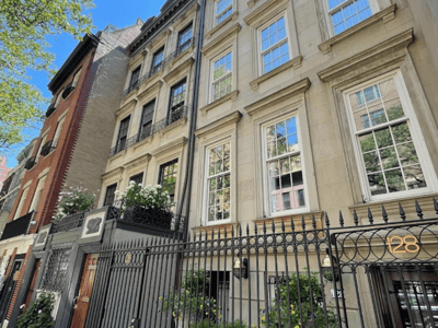 Elegant facade of historic buildings on the Upper East Side, with balconies and vegetation, illustrating New York architecture.