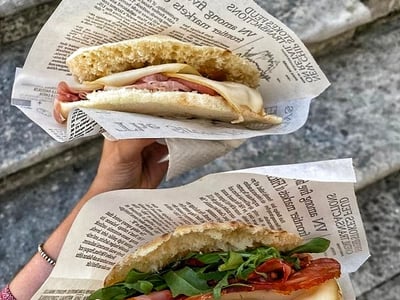 Deux sandwichs savoureux de l'Antica Pucceria Giannone, garnis de charcuterie et de fromage, montrant la richesse culinaire italienne.