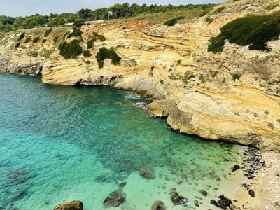 Colorful cliffs and turquoise waters at Porto Miggiano, preserved nature and Mediterranean beauty.