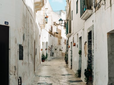 Picturesque alley of Grottaglie, with whitewashed walls and soothing flowers, offering a glimpse of the local architecture.