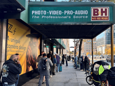Long line of customers waiting at the entrance of B&H Photo, a famous photo and video store in New York.