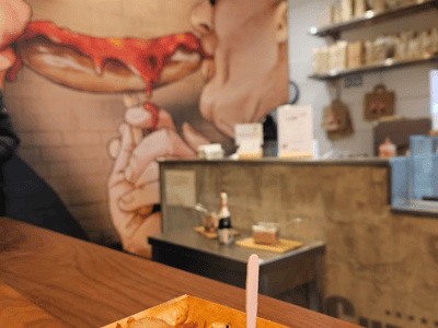 Delicious curry dish served at Curry 61, with an artistic mural depicting a convivial moment.