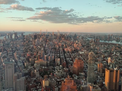 Panoramic view from SUMMIT, showcasing the city of New York at sunset, illuminating the skyscrapers.