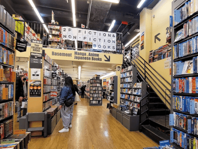 Fiction and non-fiction book section at BOOKOFF New York, with shelves filled with manga and anime.