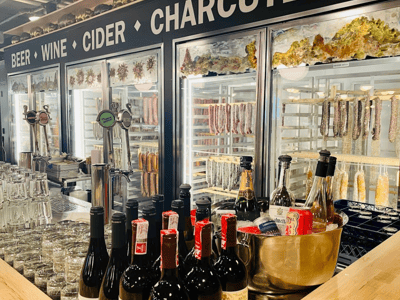 Wine and charcuterie counter at Chelsea Market, showcasing a selection of bottles and artisanal products.