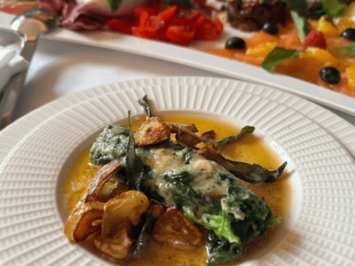 Dish of delicately prepared vegetables with flavorful sauce, served in the refined setting of Ristorante A MANO.