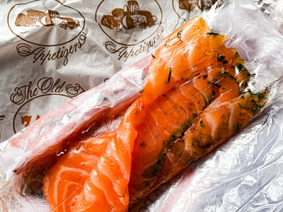 Delicately sliced smoked salmon, wrapped in Zabar's paper, highlighting the quality of the shop's specialties.