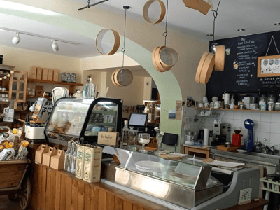 Interior of Rises Delicacies, an elegant café with refined pastries and a welcoming wooden counter.