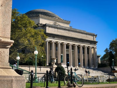 The impressive facade of Columbia University in Morningside Heights under a clear blue sky. Iconic historic building.