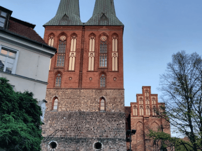 The historic church of Nikolaiviertel with its striking brick towers, emblematic of Berlin's medieval charm.